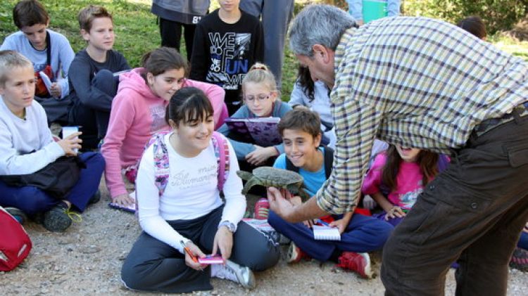 Un tècnic del Centre de Recuperació de la Tortuga de l'Albera amb un grup d'escolars © ACN