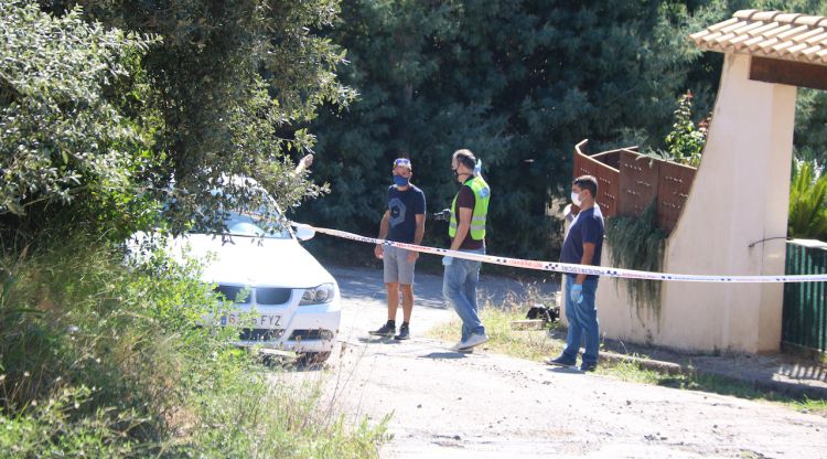 Els Mossos d'Esquadra investigant al costat d'un cotxe a la zona s'ha produït el crim. ACN